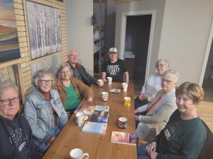 8 retirees enjoying a morning coffee together